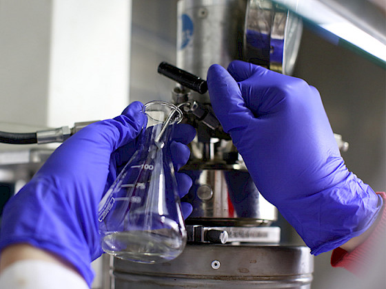 Hands handling a flask