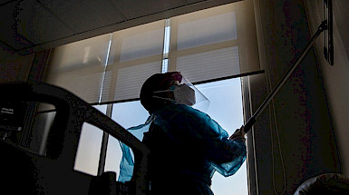 a person in a protective suit is cleaning a window