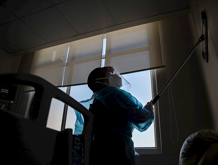 a person in a protective suit is cleaning a window