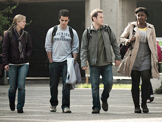 Four international students walk through the San Joaquin campus.