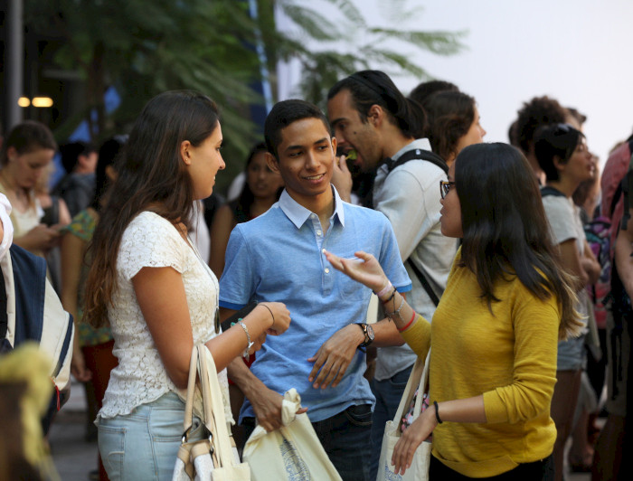 a group of people talking to each other at an event