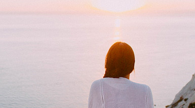 mujer mirando puesta de sol