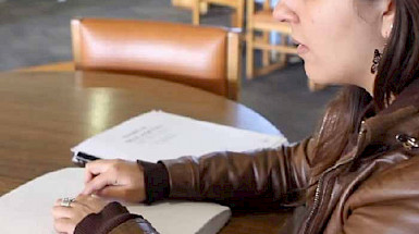 Blind student reading with her fingers.