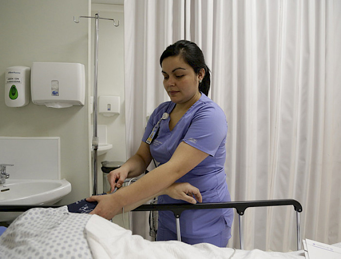 Una enfermera atiende a un paciente en camilla