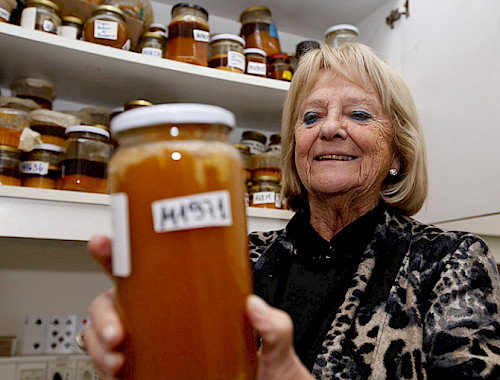 Professor Montenegro shows a jar of honey.