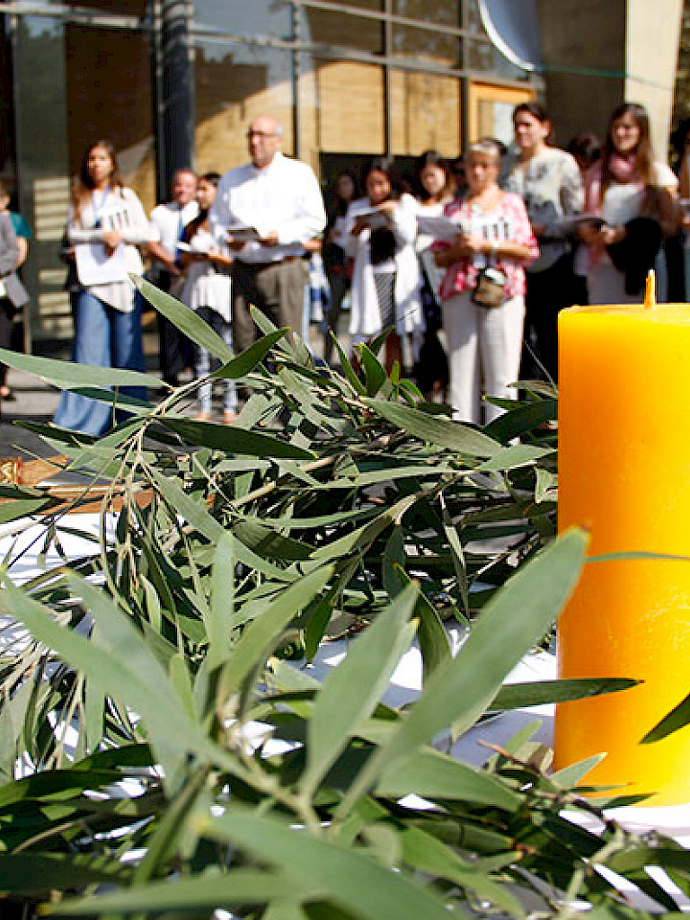 Candle on the altar surrounded by a wreath of leaves