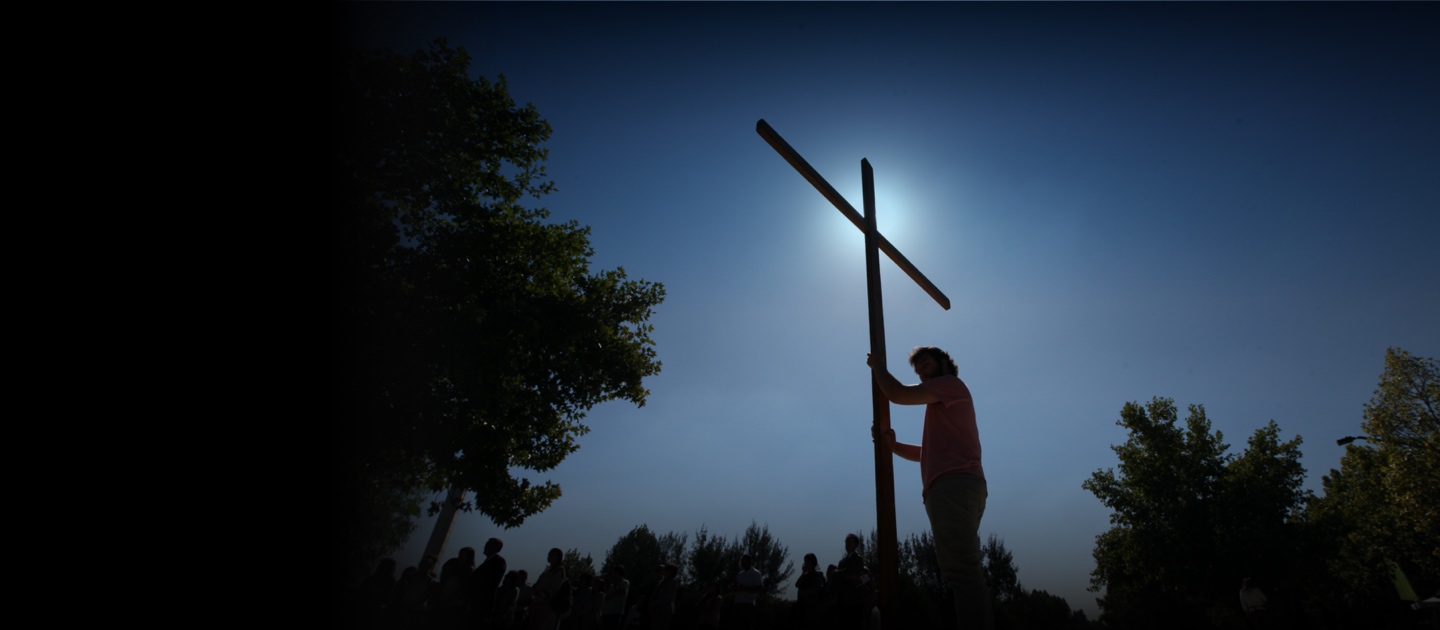 Man holding a cross.