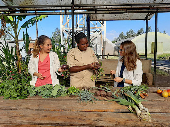 Women looking at freshly harvested vegetables.
