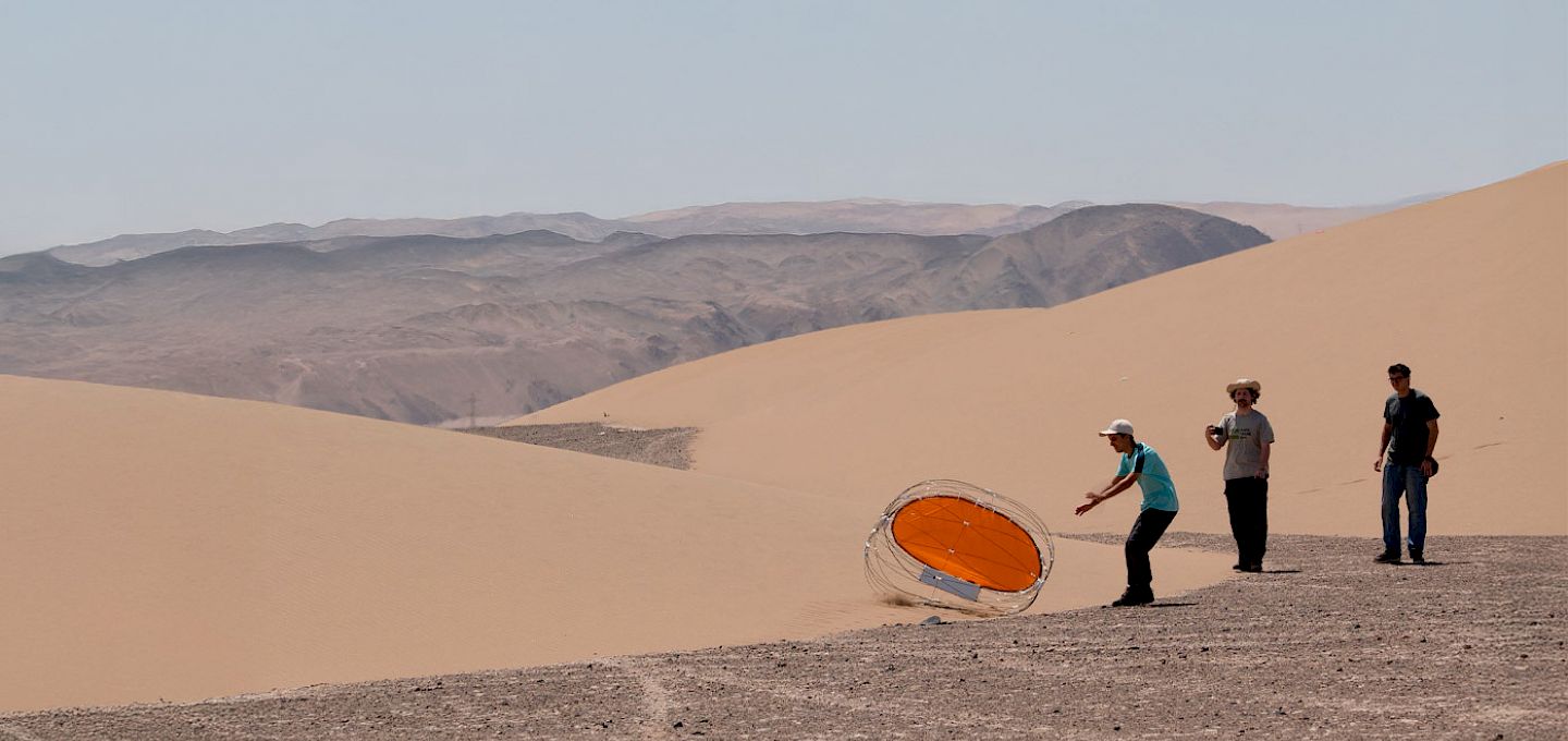 Researchers testing the rover in the dunes