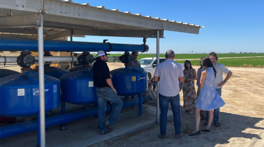 The delegation from UC Chile faculty and goverment officials are checking a filtration system in California.