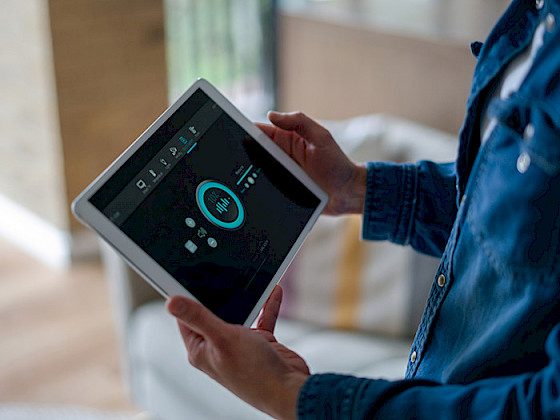 A man is holding a tablet with an AI app.