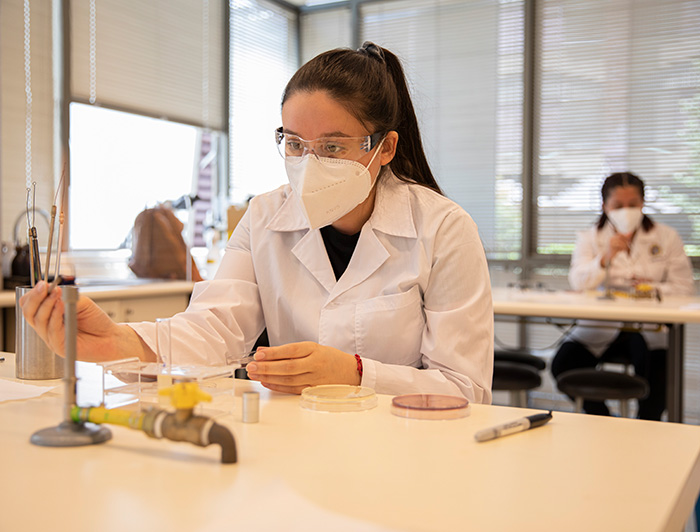 A young woman is doing research in a lab.