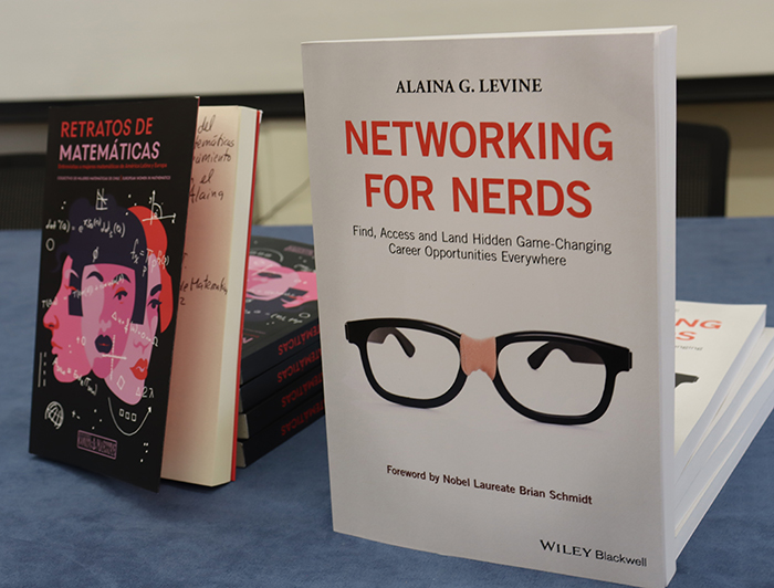 The image shows two books. On the left "Math Portrait" in a black cover. On the right "Networking for Nerds" by Alaina G. Levine in a white cover.