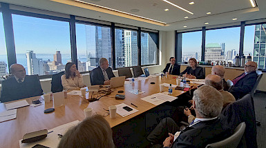 Friends UC having a meeting in a conference room in New York.