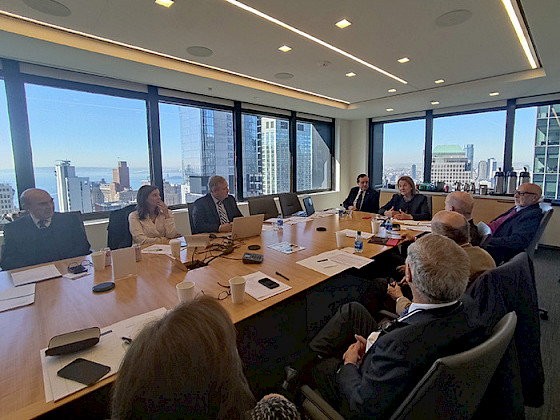 Friends UC having a meeting in a conference room in New York.