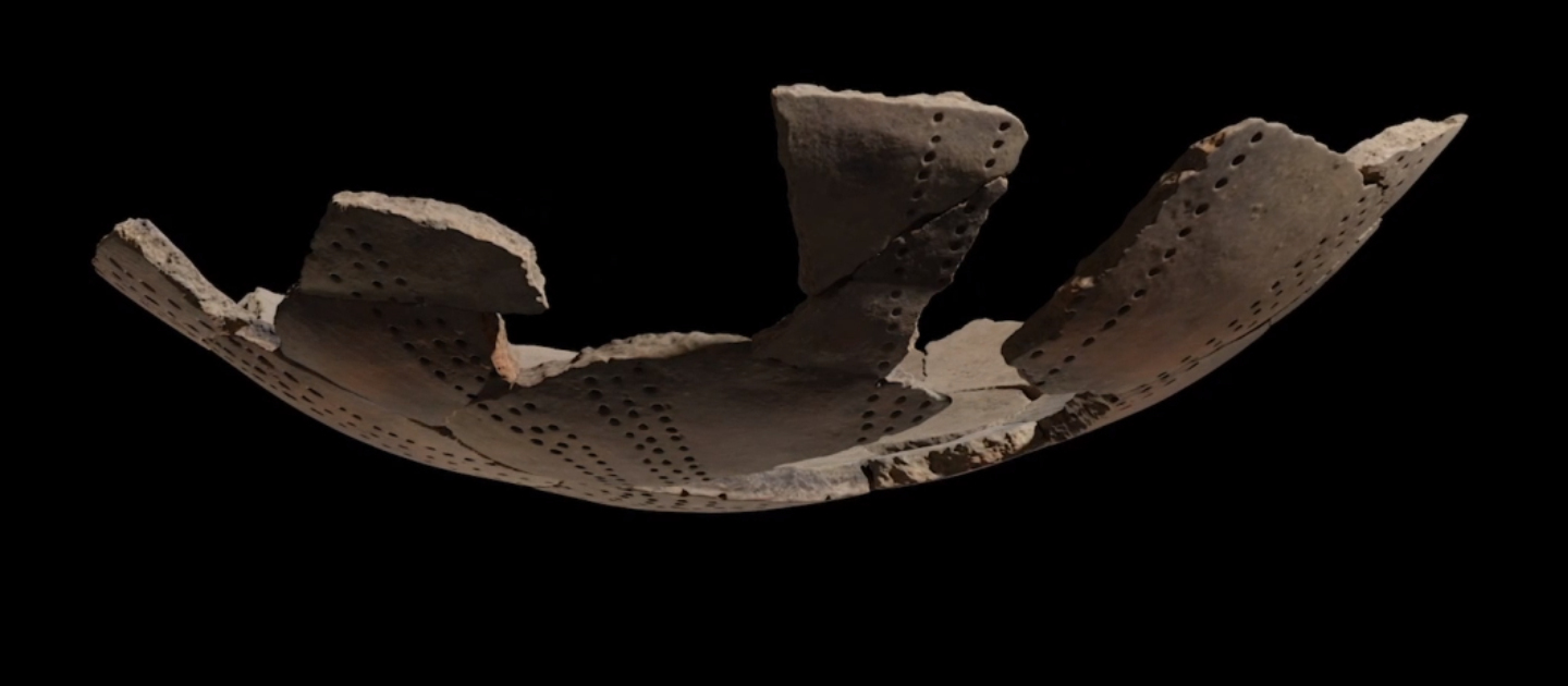 The photography shows a reconstructed ceramic in a black background.