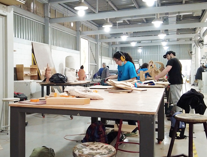 A group of people are working with wood in the lab.