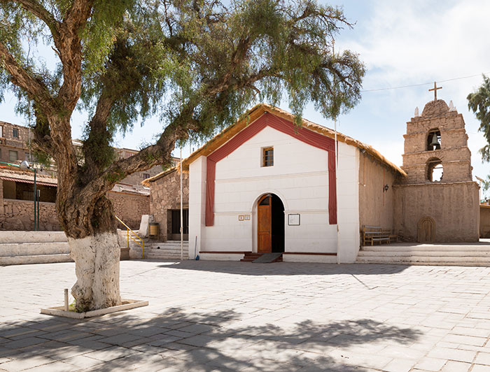 Iglesia de Ayquina con un árbol delante