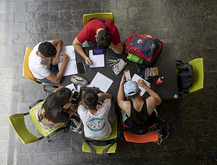 a group of students sitting around a table