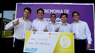 Five young man, winners of the competition, are posing with a big diploma.