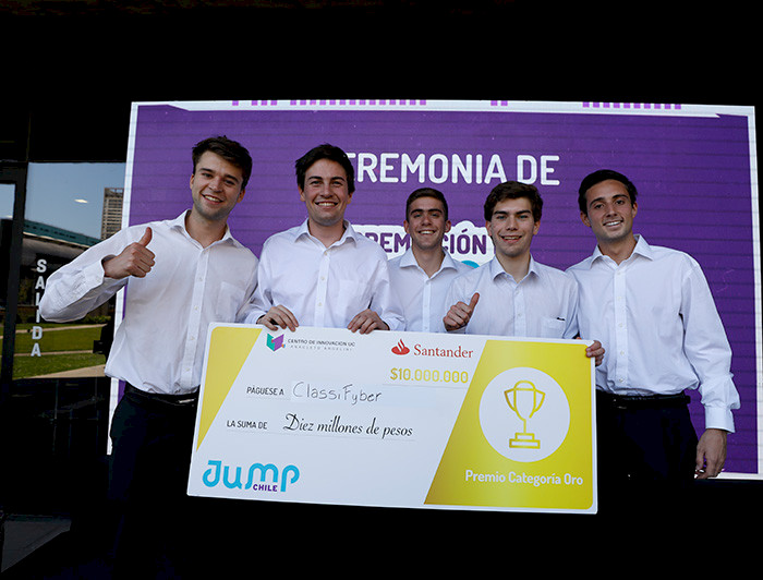 Five young man, winners of the competition, are posing with a big diploma.