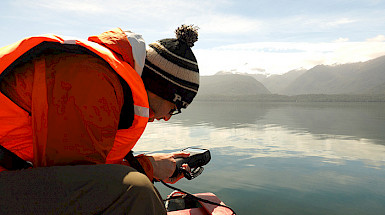 A man is doing research in a boat.