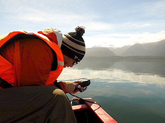 A man is doing research in a boat.