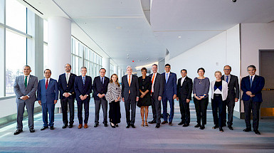 Fifteen members of the Hemispheric University Consortium are posing for the camera. Four of them are women.