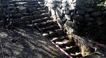 Restos arqueológicos de un muro y escalera de piedra
