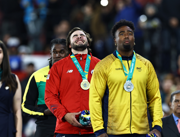 Student-athlete Lucas Nervi laughing between two other athletes.