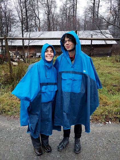 Two students wearing capes to protect themselves from the rain.