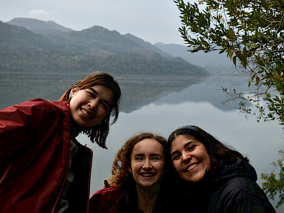 Students from UC Chile and Duke smiling, the Huilo Huilo Biological Reserve can be seen in the background.