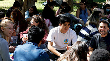 International students chat while sitting in the patio of the San Joaquin Campus.