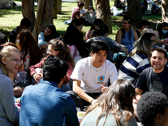 International students chat while sitting in the patio of the San Joaquin Campus.