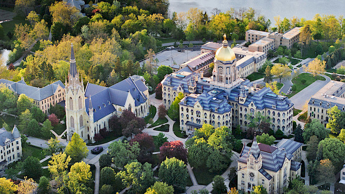 Aerial photo of the University of Notre Dame amidst trees. Credits: University of Notre Dame website.