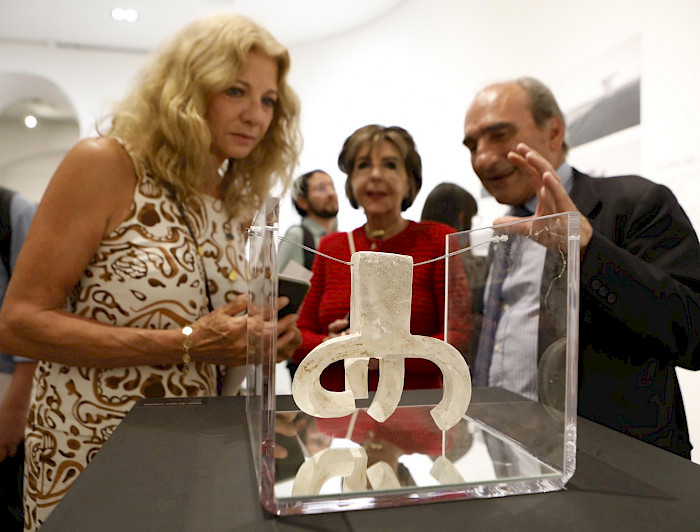 Luis Chillida with two women looking at one of his fathers artworks.