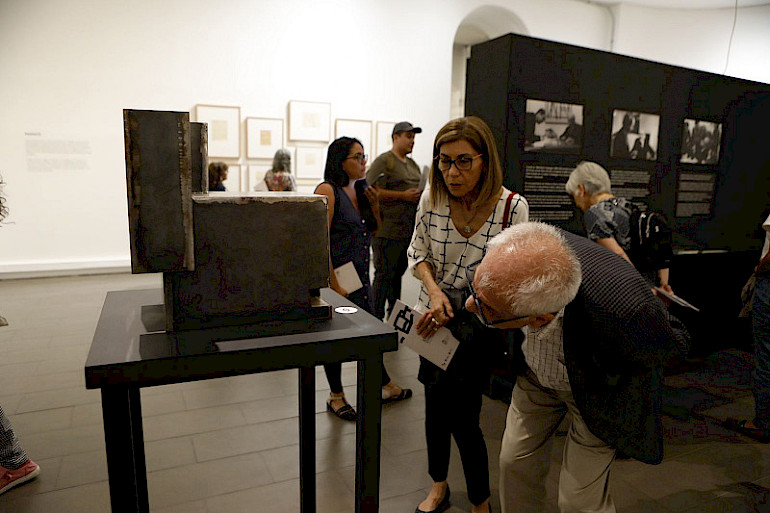 Two people looking at one of Eduardo Chillida's works.