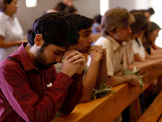 Personas en misa. Foto Pastoral UC