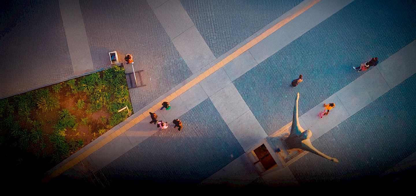 Student presenting a project to an audience and a panel of judges during the Youth Challenge to Alleviate Poverty competition at UC Chile.