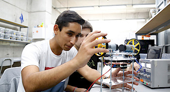 Estudiantes armando un prototipo en un laboratorio
