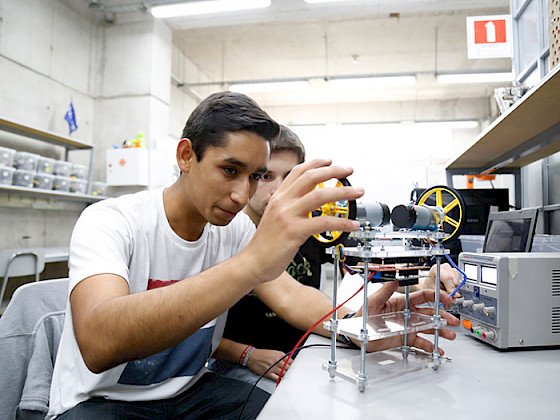 Estudiantes armando un prototipo en un laboratorio