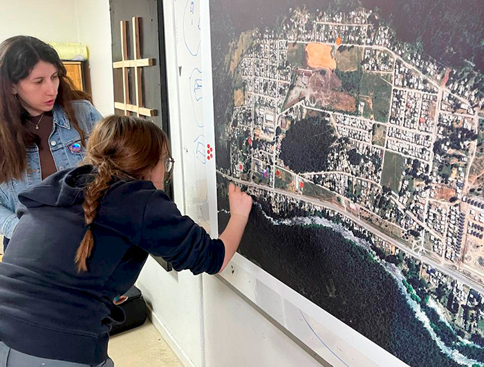 Alumna muestra un punto en un mapa.