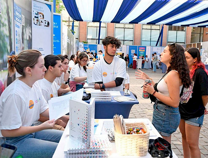 Unas jóvenes consultan en la Feria de Orientación y Postulación UC