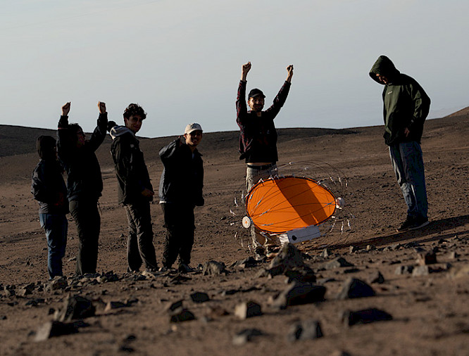 Researchers with the rover in the dunes
