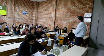 Un grupo de alumnos escucha al profesor en el el Centro de Apoyo Académico UC.