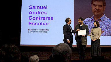Rector entregando el reconocimiento a un académico