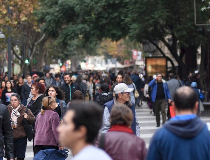 Grupo de personas caminando en la calle, mirando a todos lados. Fotografía: Encuesta Bicentenario, Centro de Políticas Públicas UC. 