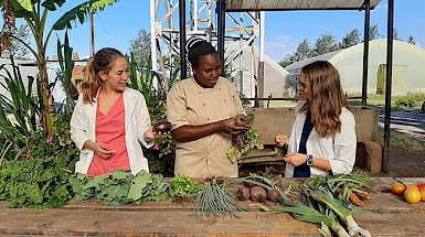 Women looking at freshly harvested vegetables.