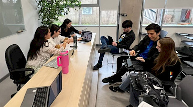 Grupo participante del Millenium Felloship trabajando juntos en una sala de clases.