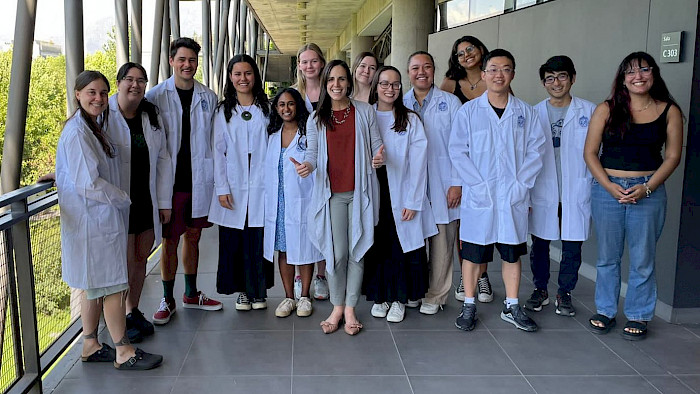 Students of the Intercultural Approaches to Public Health program wearing white coats
